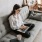Girl sitting on couch working on a laptop
