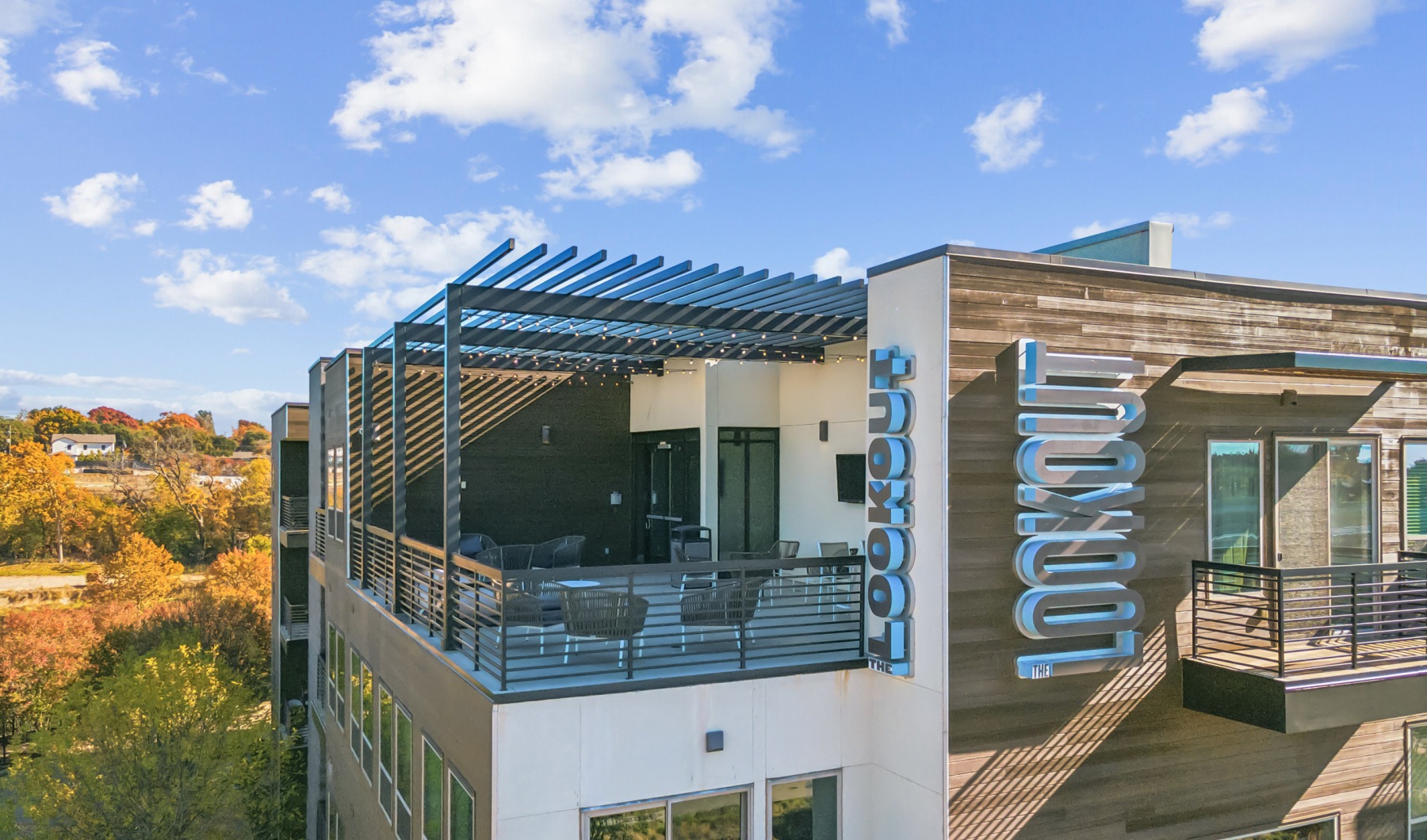 Life, Well-Rounded Exterior of building with rooftop lounge and seating