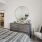 a bedroom with a mirror and a bed